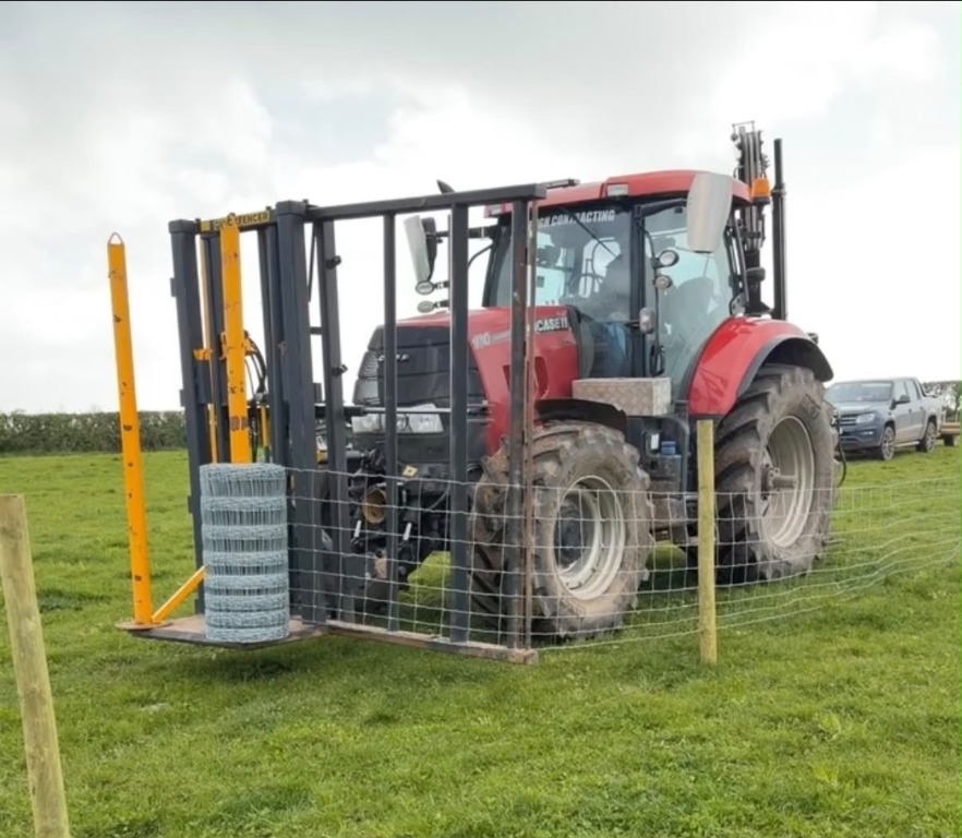 Tractor with fencing equipment beside stock-wire fencing