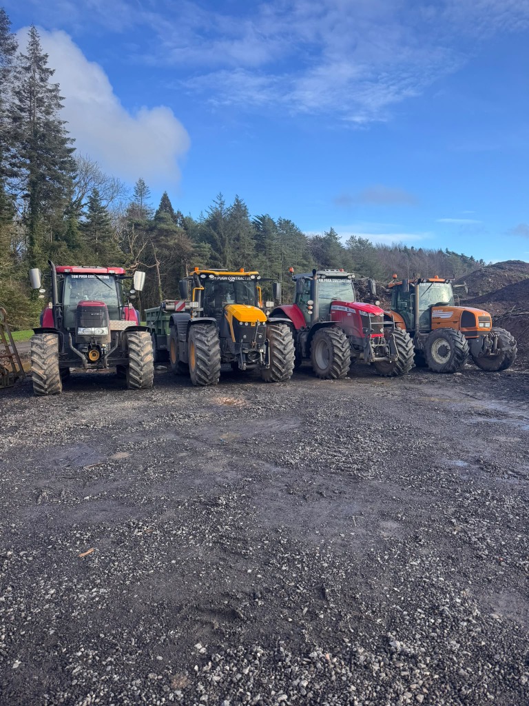 Four Tom Pugh Contracting tractors lined up in a yard