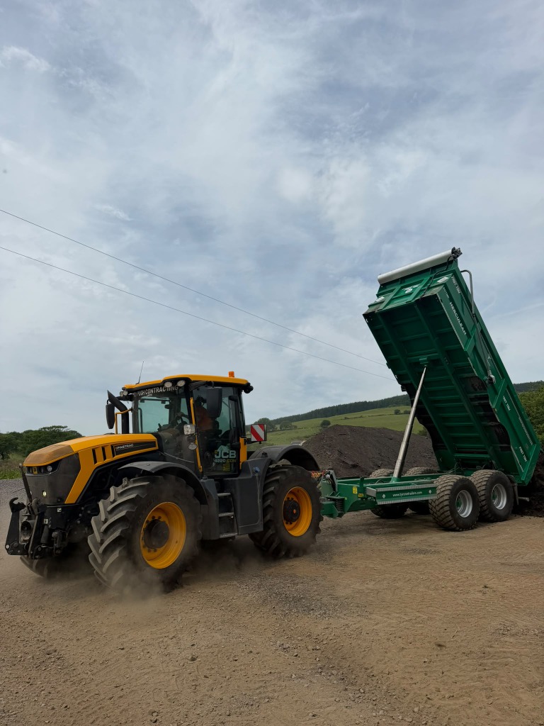 Raised tipping trailer unloading material