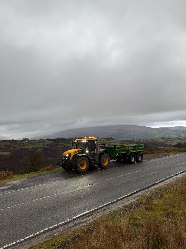 Tractor and tipping trailer on a hillside road