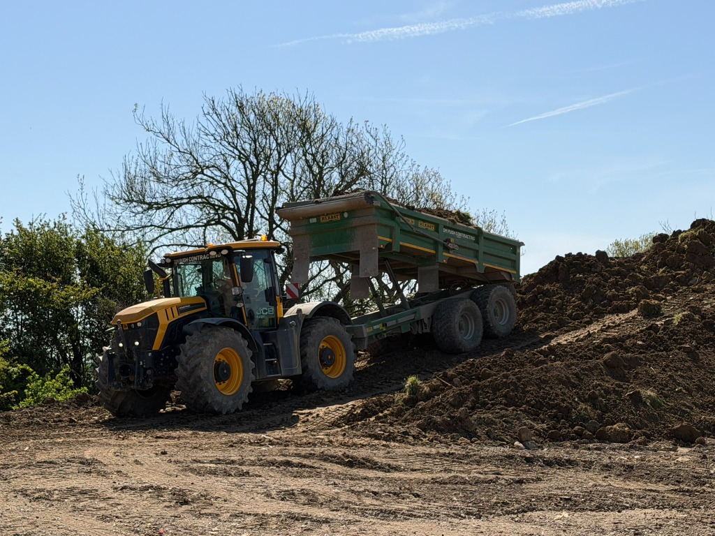 Trailer unloading soil at an earthworks site
